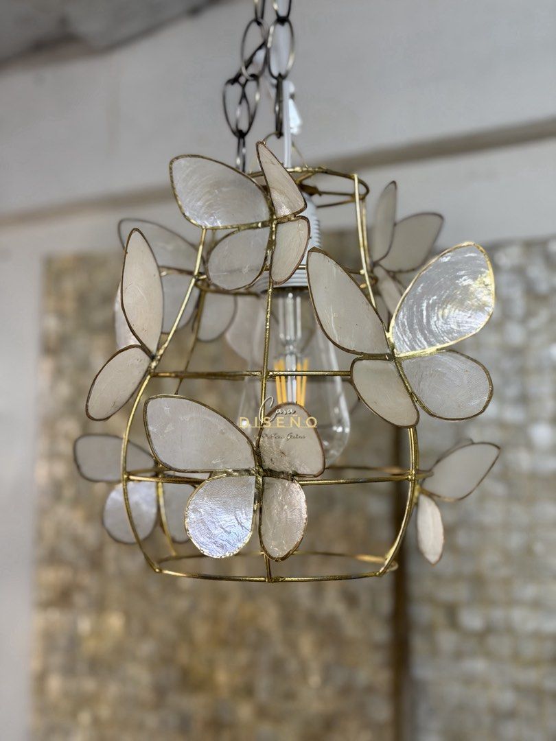 Butterfly Capiz Shell Pendant Light (Category: Lighting) located in Caloocan City. Submitted by casadisenyo (Listing ID 1442009847, Image 2). Description: - Whimsical cage pendant light - Delicate capiz shell butterfly accents - Brass finish metal frame - Includes light bulb - Ideal for nurseries and bedrooms AVAILABLE ON HAND.