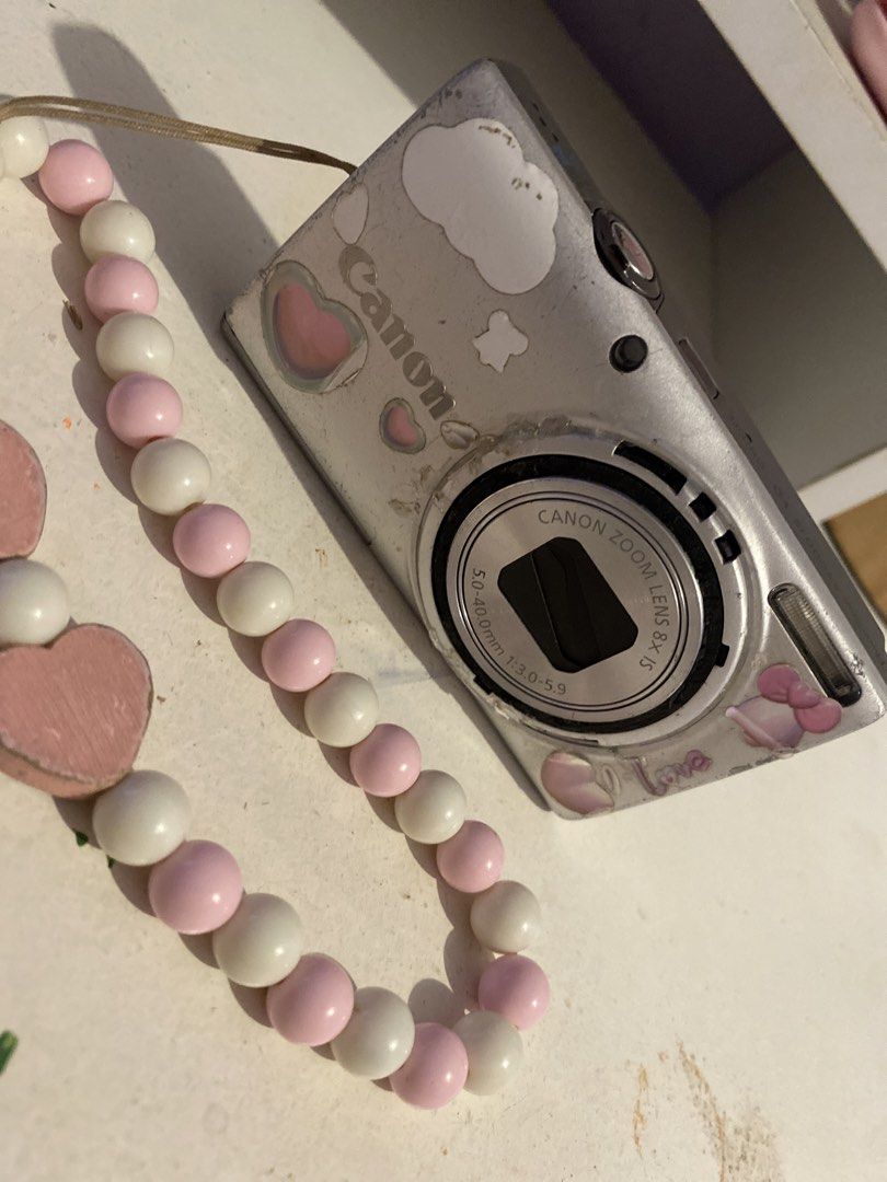 Canon Digital Camera with 8x Optical Zoom and Charm Strap (Category: Cameras) located in Agdangan. Submitted by ishameicnd (Listing ID 1442110360, Image 3). Description: - Canon digital camera - 8x optical zoom lens - Comes with fun pink and white beaded charm strap - Includes 4GB Toshiba SDHC memory card ISSUE: LENS ERROR RFS: (tinamad na mag paayos) Kunin nyo na guys malinaw ang kuha, 16 mp, working ang flash PRICE + SHIPPING FEE MOD: Gcash.