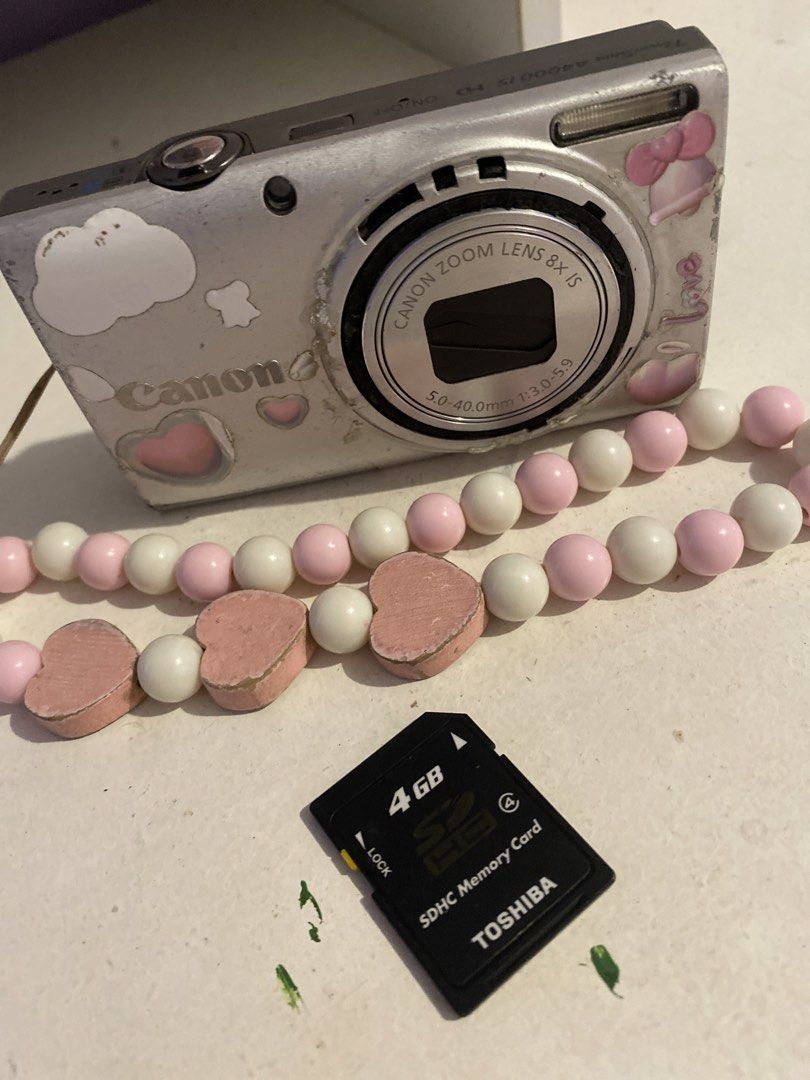 Canon Digital Camera with 8x Optical Zoom and Charm Strap (Category: Cameras) located in Agdangan. Submitted by ishameicnd (Listing ID 1442110360, Image 2). Description: - Canon digital camera - 8x optical zoom lens - Comes with fun pink and white beaded charm strap - Includes 4GB Toshiba SDHC memory card ISSUE: LENS ERROR RFS: (tinamad na mag paayos) Kunin nyo na guys malinaw ang kuha, 16 mp, working ang flash PRICE + SHIPPING FEE MOD: Gcash.