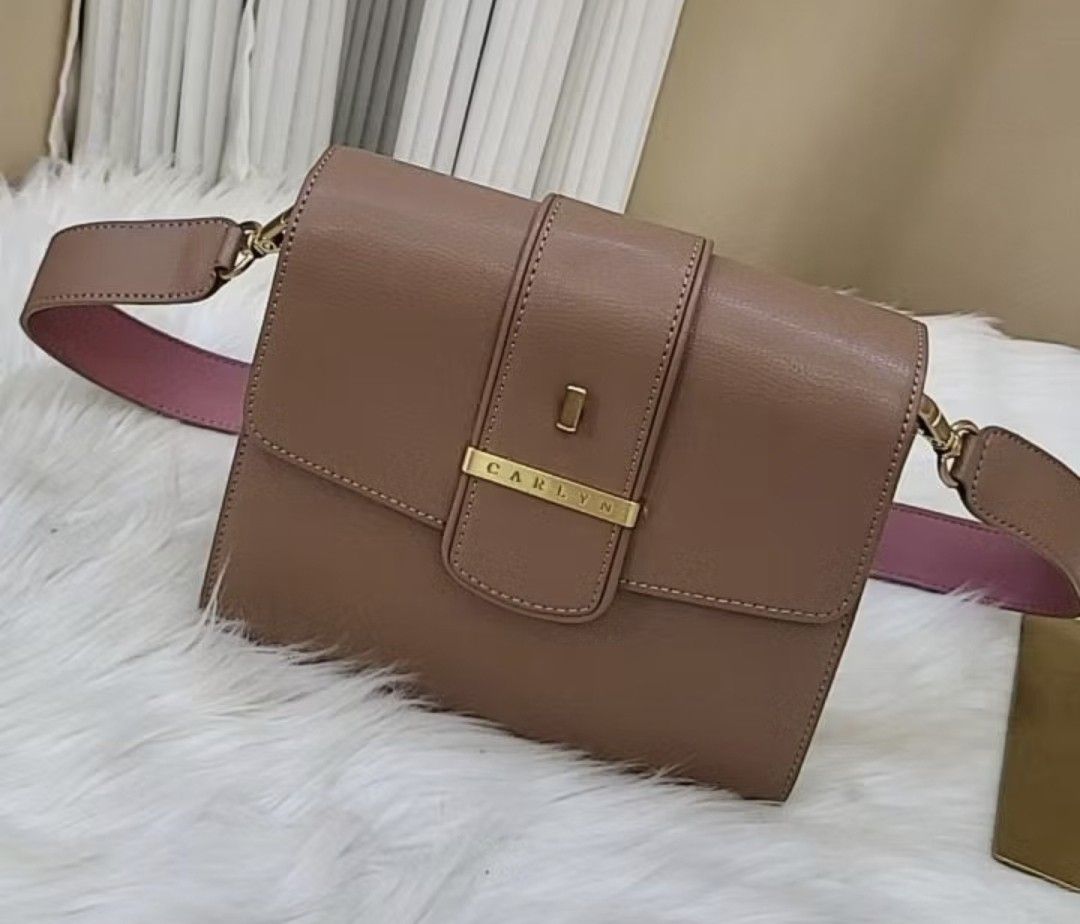 Carlyn New Hester Taupe Pink Strap (Category: Shoulder Bags) located in Makati City. Submitted by patimay (Listing ID 1442082522, Image 1). Description: - Authentic Carlyn handbag in a versatile taupe color. - Features a stylish strap with a contrasting pink lining. - Accented with elegant gold hardware details. - Clean and minimalist design, ideal for everyday use. - Perfectly sized to fit your daily essentials..