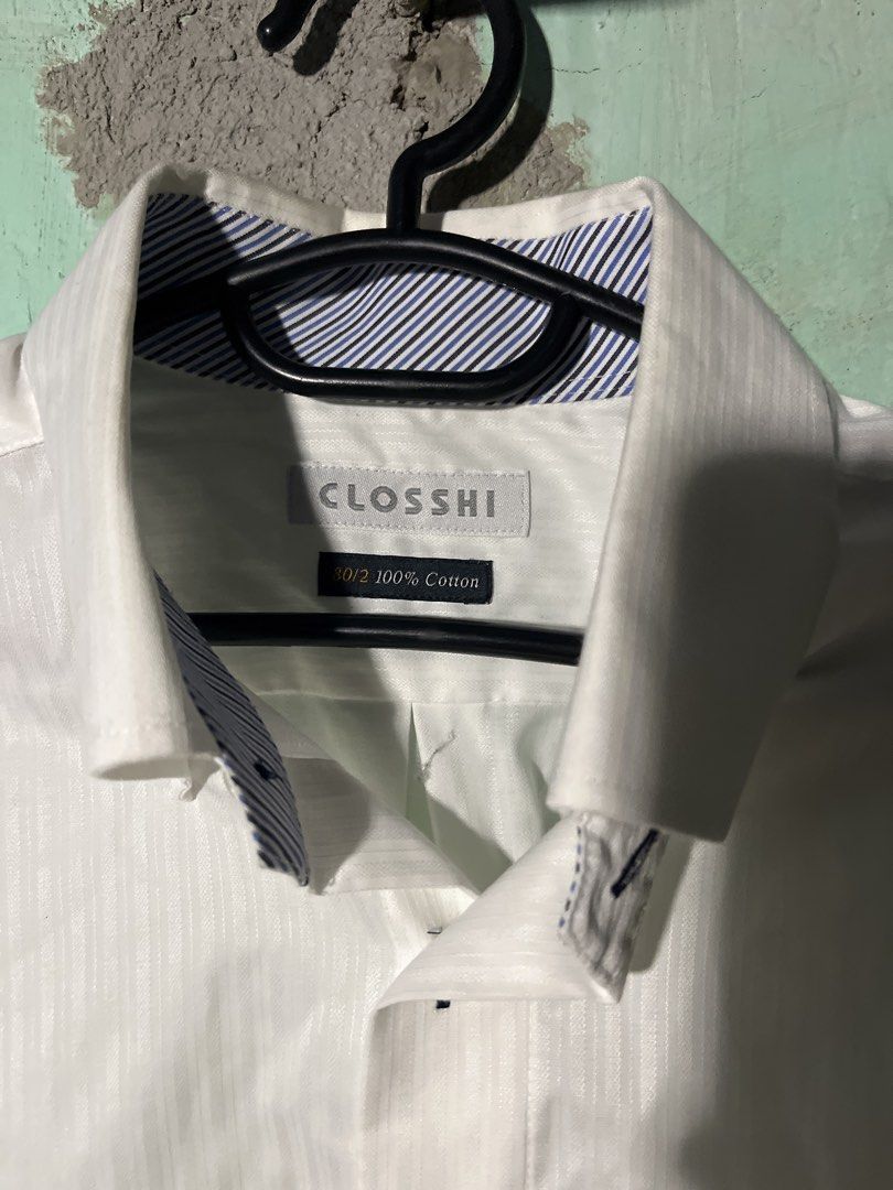 CLOSSHI White Striped Long Sleeve Button Down Shirt (Category: Formal Shirts) located in Manila. Submitted by extremefever31 (Listing ID 1442023843, Image 2). Description: - Brand: CLOSSHI - Color: White - Style: Long sleeve dress shirt - Pattern: Subtle vertical stripes - Material: 100% Cotton - Features: Button-down front, chest pocket, classic collar with button details - Versatility: Suitable for both formal and casual wear.