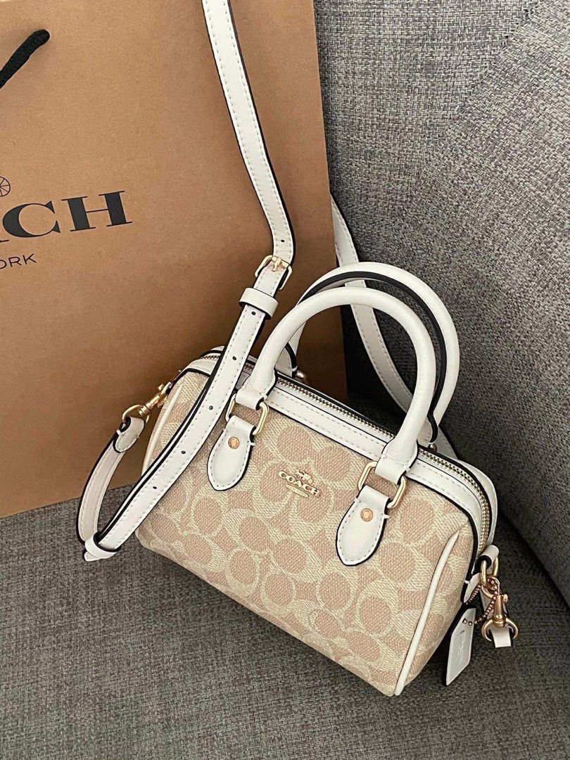 Coach Barrel Bag with Cherry Charm (Category: Luxury Bags & Wallets) located in Manila. Submitted by declutbykai (Listing ID 1441984973, Image 1). Description: - Cute Coach barrel bag - Classic monogram print with white trim - Top handles and detachable crossbody strap - Includes a fun cherry charm - Free charm and paperbag.