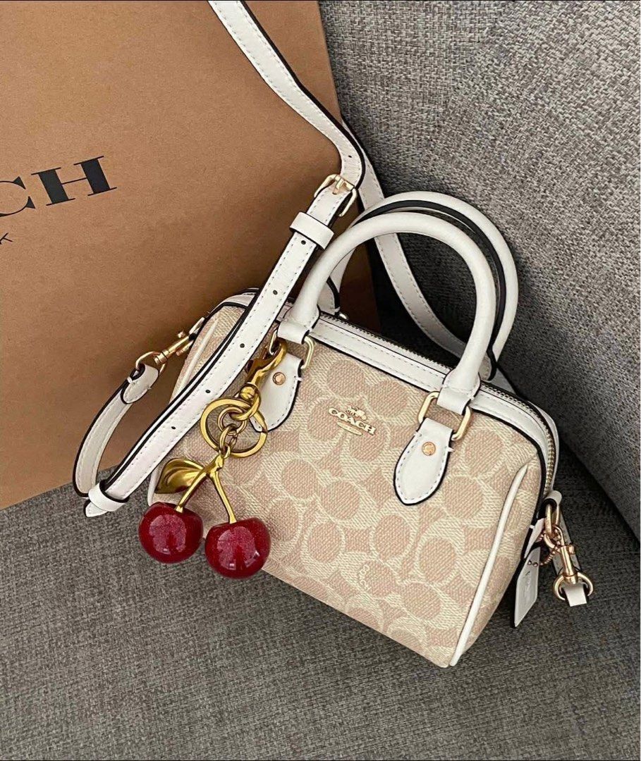 Coach Barrel Bag with Cherry Charm (Category: Luxury Bags & Wallets) located in Manila. Submitted by declutbykai (Listing ID 1441984973, Image 3). Description: - Cute Coach barrel bag - Classic monogram print with white trim - Top handles and detachable crossbody strap - Includes a fun cherry charm - Free charm and paperbag.