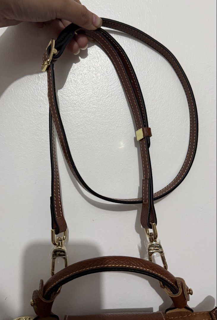 Cognac Longchamp Mini Xs Top Handle Bag with straps (Category: Luxury Bags & Wallets) located in Manila. Submitted by _girlfinds (Listing ID 1440154544, Image 3). Description: 👜 LONGCHAMP LE PLIAGE – JAPAN SOURCED, YES TO RUSH SHIPPING! Elevate your daily style with this classic and functional Longchamp tote. 📍 Sourced directly from Japan – self authentication with the provided photos, premium quality. ➕ Want a comfier grip? 💼 Add ₱300 for thi