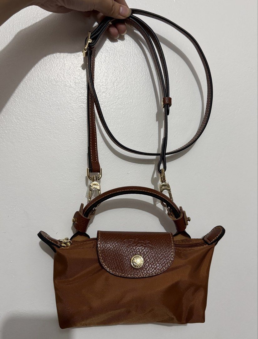 Cognac Longchamp Mini Xs Top Handle Bag with straps (Category: Luxury Bags & Wallets) located in Manila. Submitted by _girlfinds (Listing ID 1440154544, Image 2). Description: 👜 LONGCHAMP LE PLIAGE – JAPAN SOURCED, YES TO RUSH SHIPPING! Elevate your daily style with this classic and functional Longchamp tote. 📍 Sourced directly from Japan – self authentication with the provided photos, premium quality. ➕ Want a comfier grip? 💼 Add ₱300 for thi