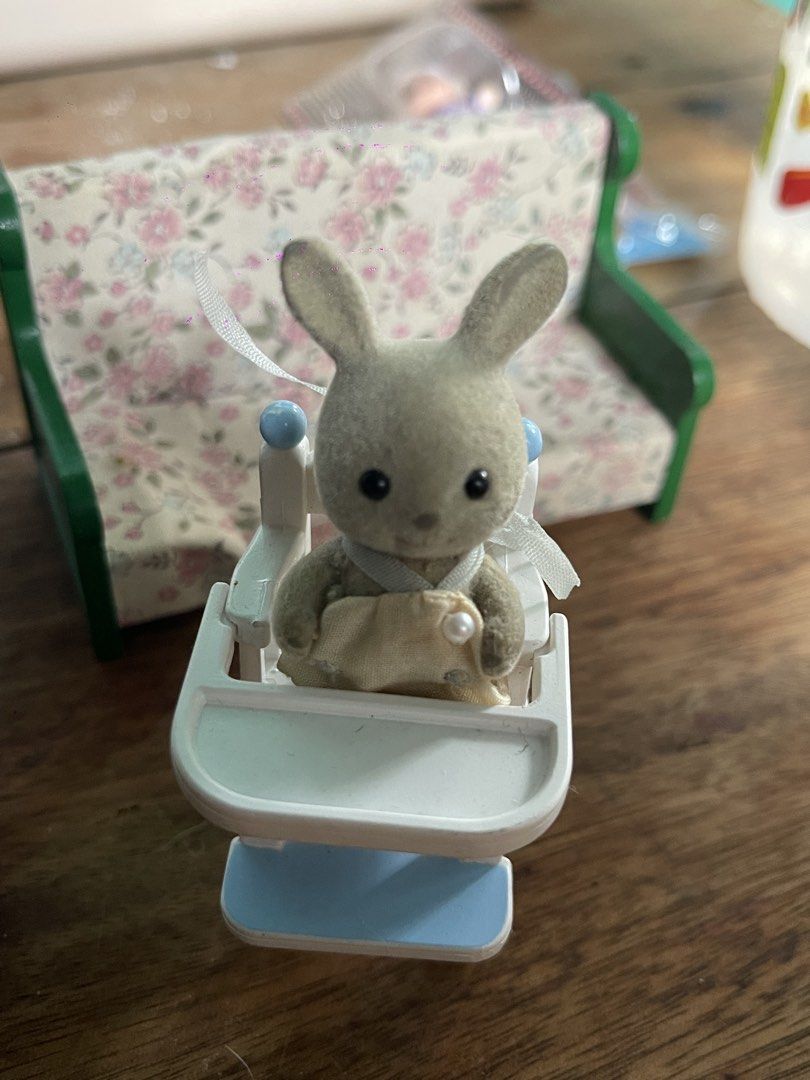 Epoch Sylvanian Families Bunny Baby High Chair & Sofa (Category: Kids Tables & Chairs) located in Muntinlupa City. Submitted by wgesez5uji (Listing ID 1442114585, Image 1). Description: - Sylvanian Families bunny baby set - Includes white and blue high chair - Features a cute bunny wearing a bib - Comes with a small floral sofa - Ideal for imaginative pretend play - Made by Epoch Co., Ltd..