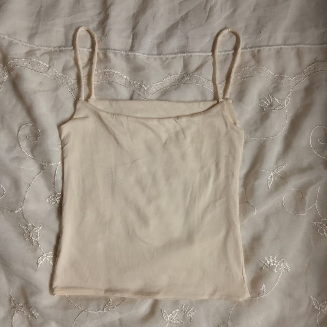 FHILAR Cream Spaghetti Strap Tank Top Size M (Category: Sleeveless) located in Talisay. Submitted by peonisces (Listing ID 1442116571, Image 2). Description: ๑ fits medium ๑ color rate: 10/10 (CREAM) RFS: will buy other size hihi - Cream-colored tank top from FHILAR - Spaghetti straps - Size Medium (M) - Made of soft material - Perfect for layering or wearing on its own - Comfortable and stylish.