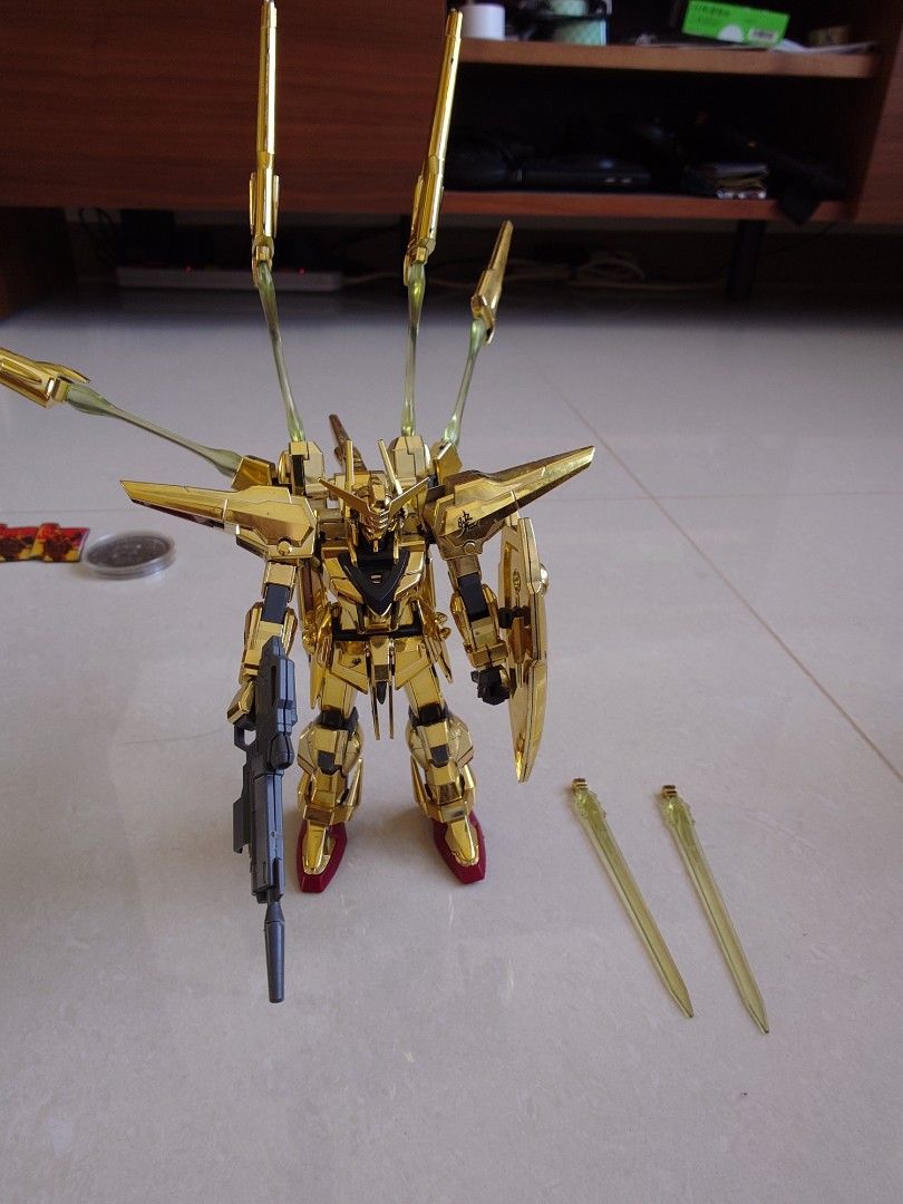 Gold Frame Gundam Model Kit with Accessories (Category: Gundam Model Kits) located in Singapore. Submitted by mj28 (Listing ID 1441994465, Image 1). Description: - Gold frame Gundam model - Includes rifle and two beam sabers - Features clear gold parts - Ideal for collectors and display - What you see is what you get.