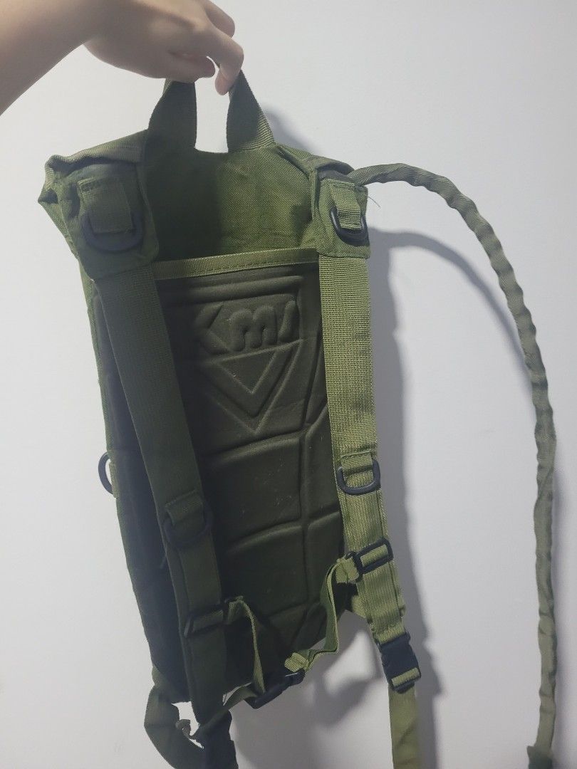 Green Hydration Pack Backpack (Category: Backpacks) located in Manila. Submitted by mija.shop (Listing ID 1442110462, Image 2). Description: - Durable green canvas hydration pack - Large cap for easy filling - Adjustable straps for a comfortable fit - Padded back for enhanced comfort - Ideal for outdoor activities or as a unique prop - Built with durable material for longevity - Features a unique and eye-catching design.
