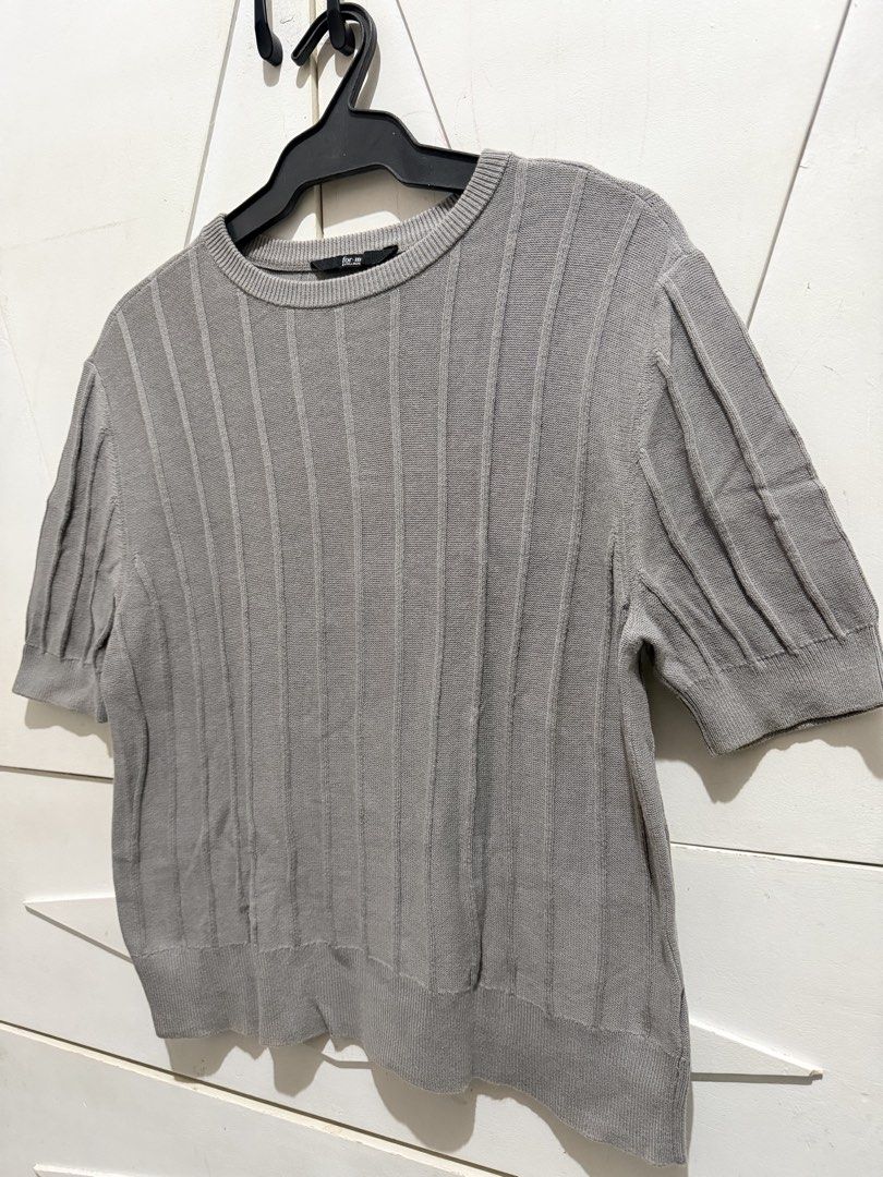 Grey Ribbed Knit Short Sleeve Top (Category: Blouses) located in Muntinlupa City. Submitted by jaja.0903 (Listing ID 1442124491, Image 3). Description: - Grey short sleeve knit top - Vertical ribbed detailing - Crew neck - Slightly cropped length - Subtle puff sleeve detail - Versatile: pairs easily with jeans or skirts.