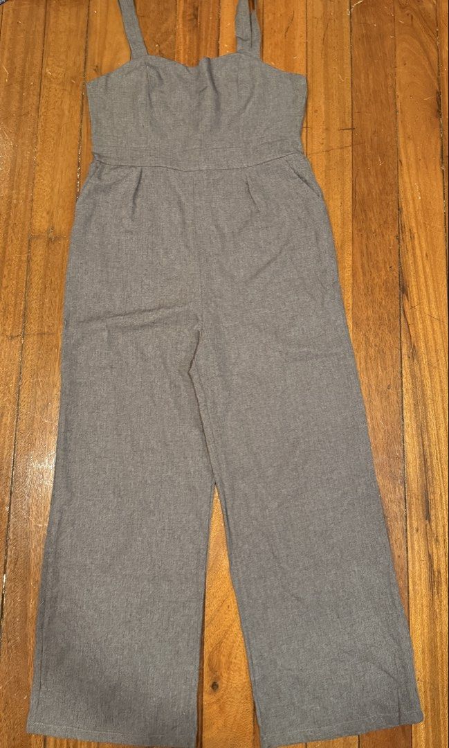 Grey Wide Leg Jumpsuit with Straps (Category: Jumpsuits) located in Pasig City. Submitted by atbp__ (Listing ID 1442121729, Image 1). Description: - Grey wide-leg jumpsuit - Adjustable straps - Sweetheart neckline - Side pockets - Minor marks on front (please check photos) - Perfect for dressing up or down.