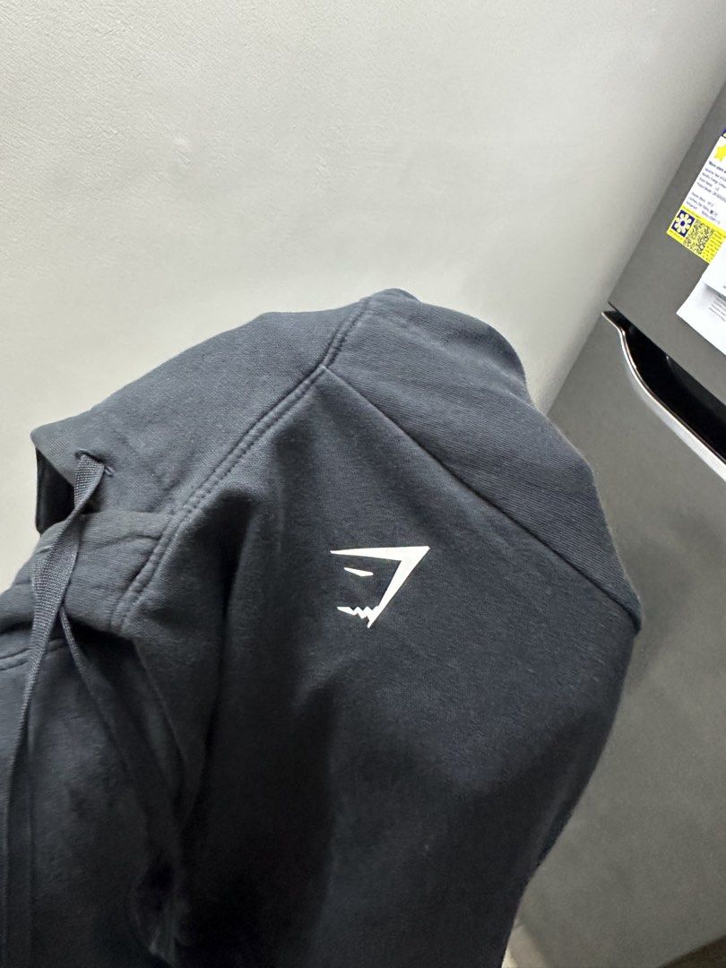 Gymshark Black Hoodie Size S (Category: Hoodies) located in Manila. Submitted by frederick0007 (Listing ID 1442093063, Image 2). Description: - Black Gymshark hoodie - Gymshark logo on chest - Made in Madagascar - Size S - Ideal for workouts or casual wear Size small on tag but also fits to XS.