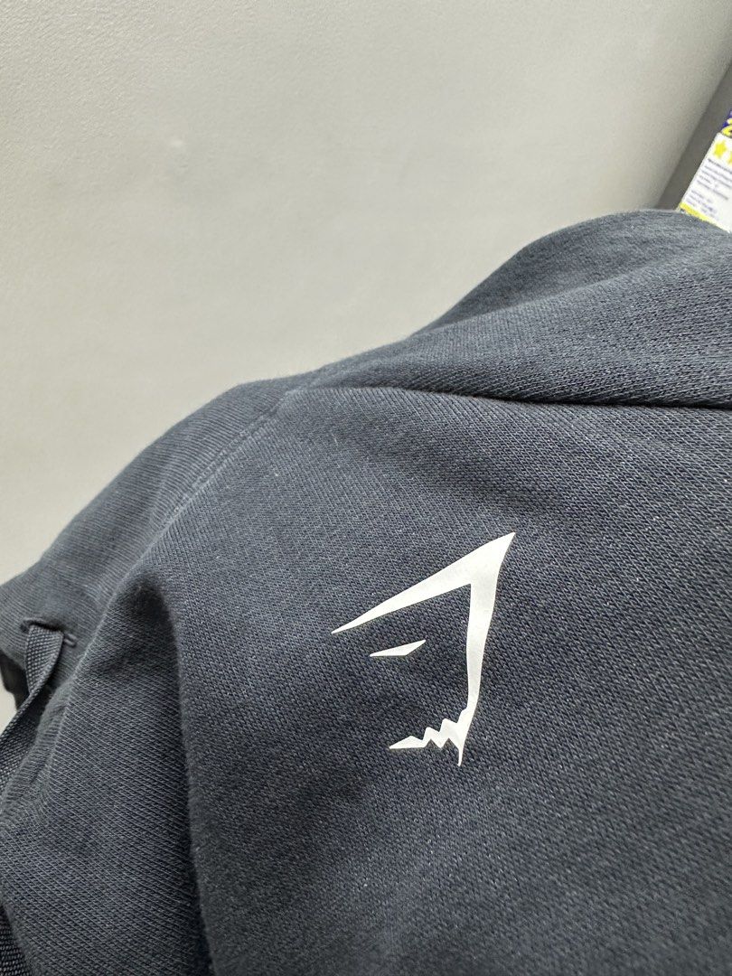Gymshark Black Hoodie Size S (Category: Hoodies) located in Manila. Submitted by frederick0007 (Listing ID 1442093063, Image 1). Description: - Black Gymshark hoodie - Gymshark logo on chest - Made in Madagascar - Size S - Ideal for workouts or casual wear Size small on tag but also fits to XS.