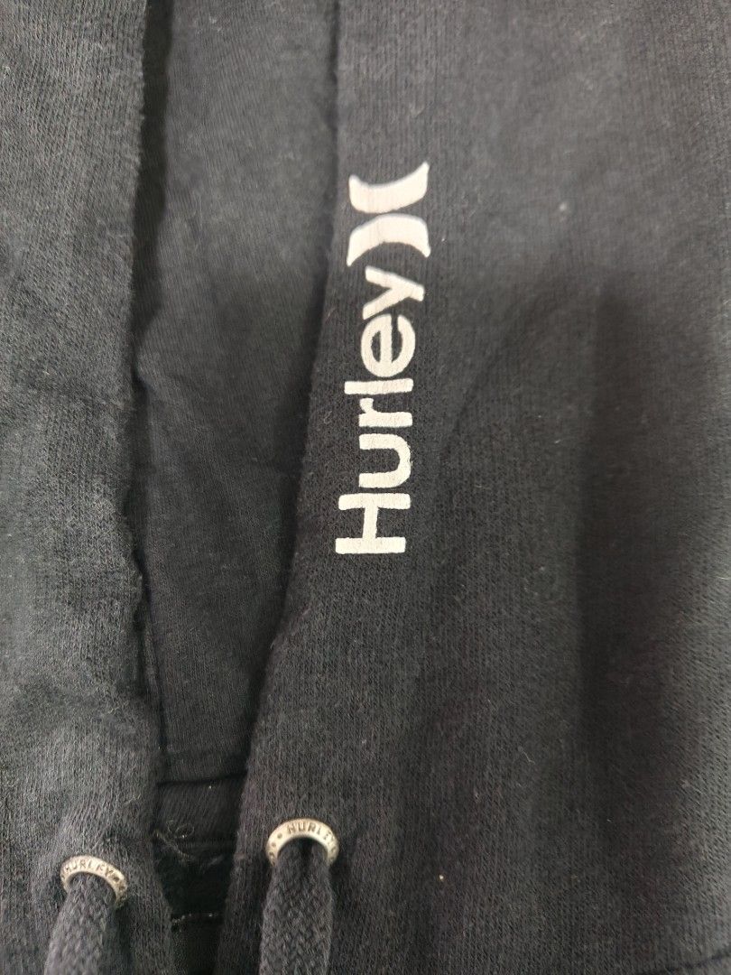 Hurley Black Hoodie Size L (Category: Hoodies) located in Cavite. Submitted by whew12 (Listing ID 1442009283, Image 2). Description: - Black Hurley hoodie - Size L - Large Hurley logo on chest - Smaller logos on sleeves - Front pocket - Hooded design - Cotton-polyester blend fabric - Ideal for casual wear.