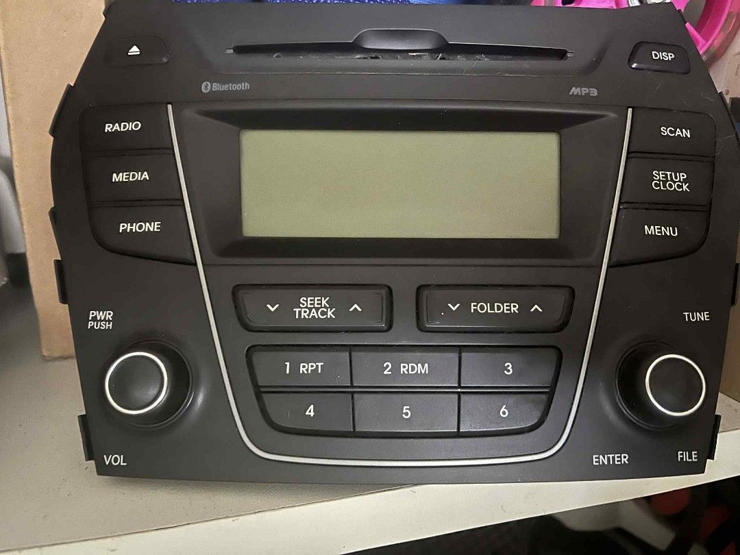 Hyundai Santa Fe 2014 head unit (Category: Audio, Video, Alarm and other Electronic Accessories) located in Cainta. Submitted by jdmr25 (Listing ID 1442152320, Image 1). Description: - Genuine head unit for Hyundai Santa Fe 2014 - Features Bluetooth, MP3 playback, Radio, Media, and Phone functions - Includes volume control, tuning, track/folder navigation, and power button - Direct replacement part - Good working condition.