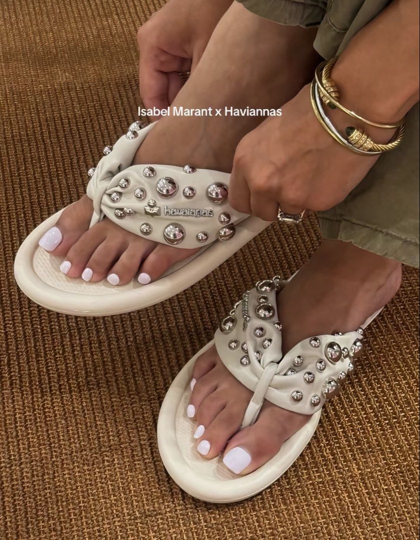 (RUSH) Isabel Marant x Havaianas White Studded Flip Flops (Category: Slippers and slides) located in Mandaluyong City. Submitted by happywater.11a036 (Listing ID 1441984080, Image 1). Description: - Authentic Isabel Marant x Havaianas collaboration - Chic white flip flops - All-over silver stud embellishments on straps - Unique twisted strap design - Comfortable and stylish for everyday wear - Ideal for beach days and casual outings.