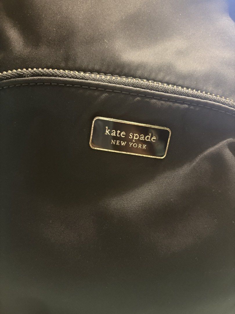 Kate Spade New York Black Nylon Backpack (Category: Backpacks) located in Manila. Submitted by budgetpreloveditems (Listing ID 1442106051, Image 2). Description: - Authentic Kate Spade backpack in classic black. - Crafted from high-quality nylon with elegant leather accents. - Features stylish gold-tone hardware on all zippers. - Includes a convenient top handle and adjustable shoulder straps for comfortable carrying. - Front zippered pocket for 