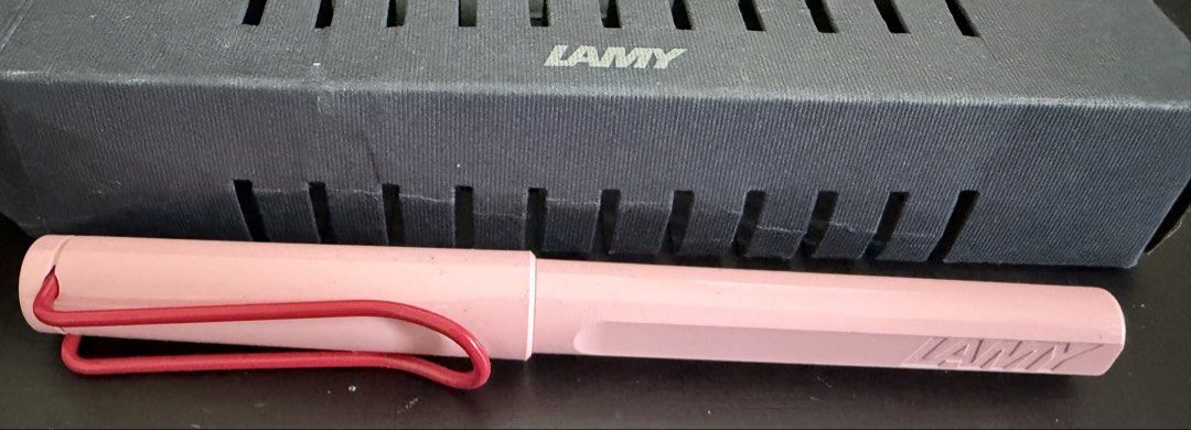 LAMY ball point Pen - Pink (Category: Stationery & School Supplies) located in Singapore. Submitted by ratandsnake (Listing ID 1442046160, Image 1). Description: - LAMY ball point pen - Lovely pastel pink color - Contrasting red clip - Includes original box - Ideal for everyday writing or as a gift - Classic and timeless design.