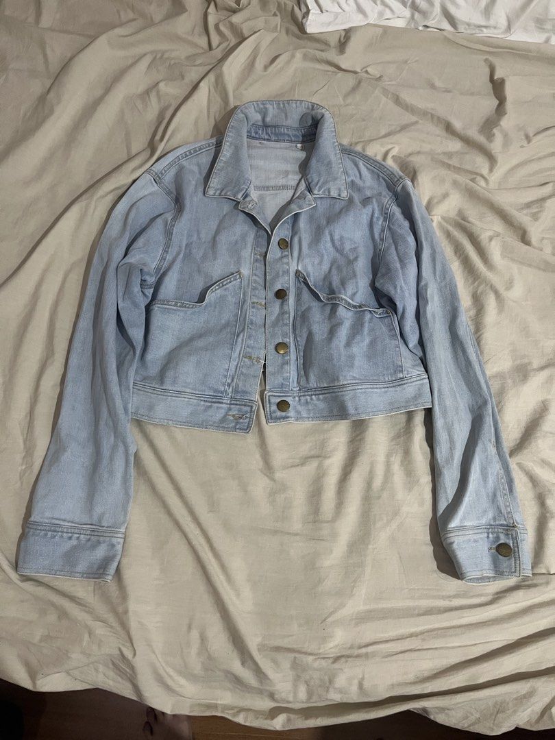 Light Wash Cropped Denim Jacket (Category: Coats, Jackets and Outerwear) located in Manila. Submitted by mxinii (Listing ID 1442113187, Image 1). Description: - Light wash denim jacket - Cropped style - Button-up front - Two chest pockets - Long sleeves with button cuffs - Small mark on left sleeve near cuff - Versatile wardrobe staple.