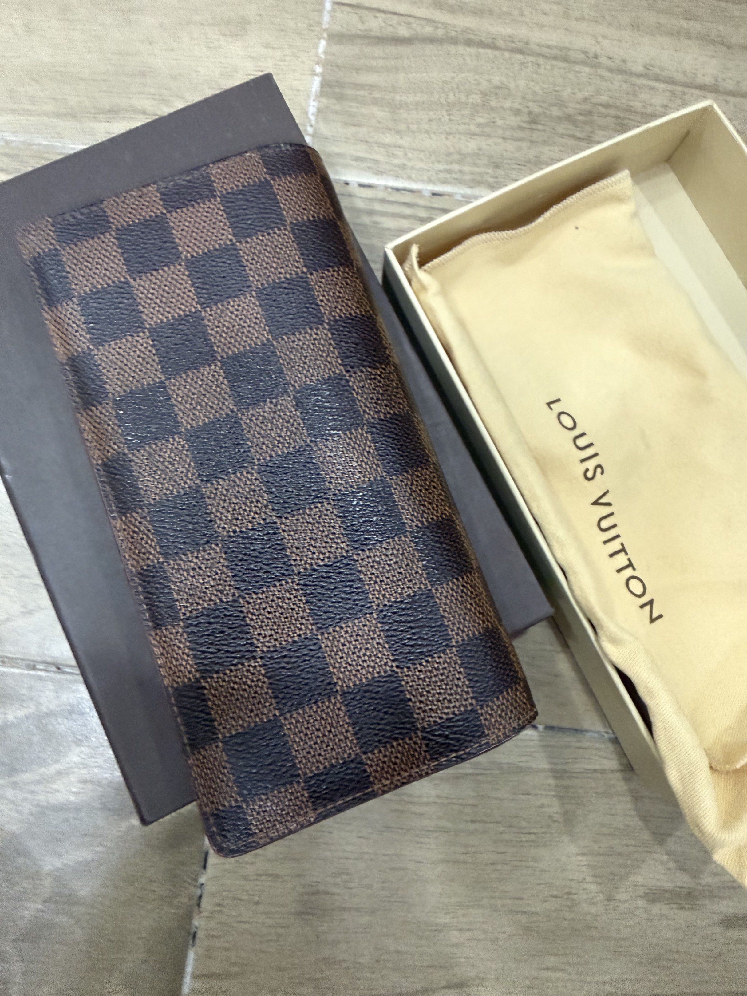 Louis Vuitton Damier Ebene Long Wallet Complete Set (Category: Luxury Bags & Wallets) located in Santa Rosa. Submitted by jdoria (Listing ID 1441986966, Image 2). Description: - Authentic Louis Vuitton wallet - Damier Ebene canvas - Long bifold style - Multiple card slots - Zip compartment - Includes original box and dust bag - Perfect for organizing essentials - Ranking: 8.5 out of 10.