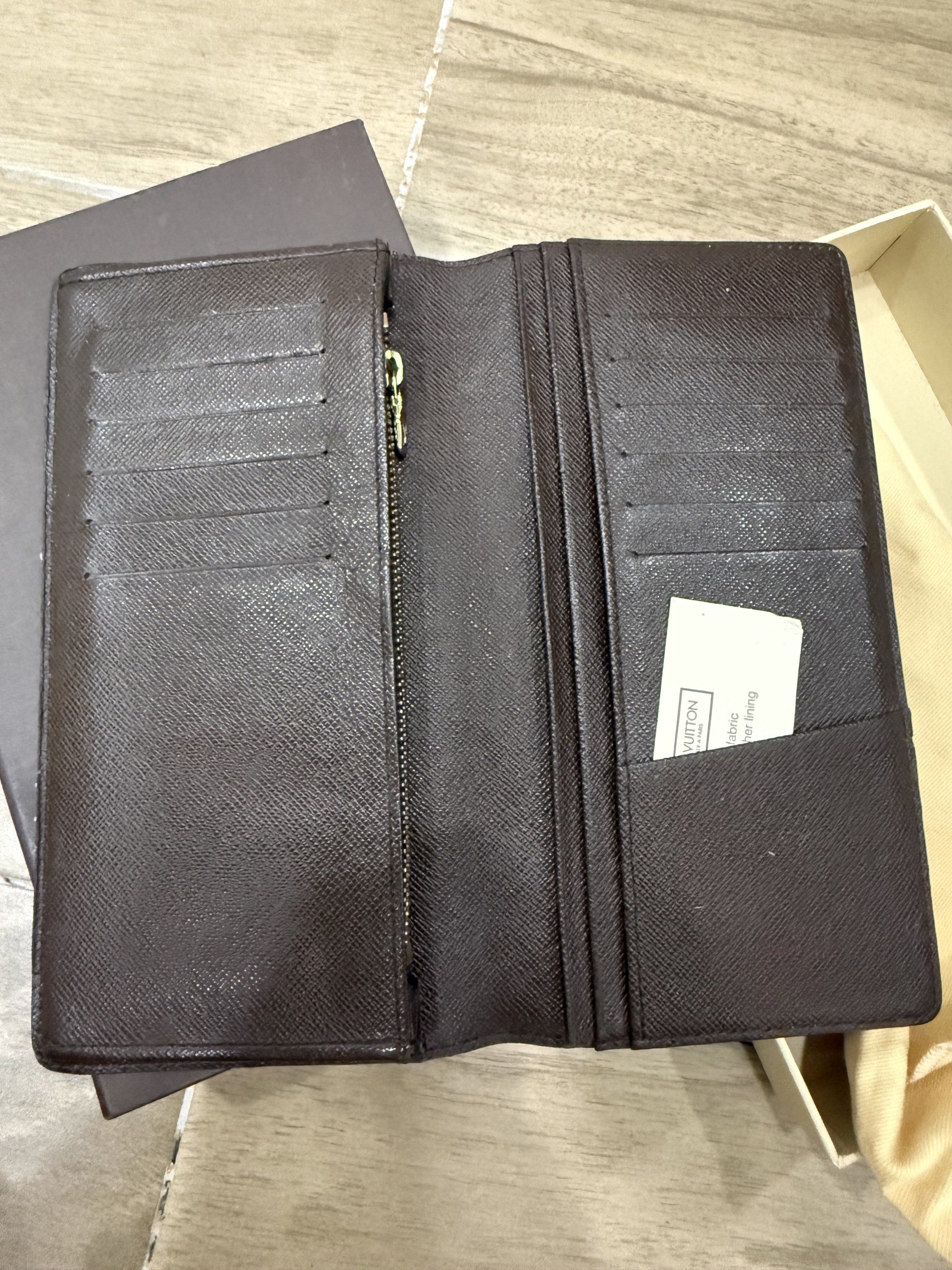 Louis Vuitton Damier Ebene Long Wallet Complete Set (Category: Luxury Bags & Wallets) located in Santa Rosa. Submitted by jdoria (Listing ID 1441986966, Image 3). Description: - Authentic Louis Vuitton wallet - Damier Ebene canvas - Long bifold style - Multiple card slots - Zip compartment - Includes original box and dust bag - Perfect for organizing essentials - Ranking: 8.5 out of 10.