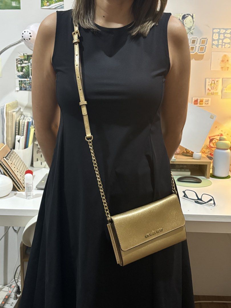 Michael Kors sling bag (Category: Shoulder Bags) located in Antipolo. Submitted by hatd0gger (Listing ID 1436223469, Image 3). Description: Pre-loved authentic MK sling bag Price: 4k (negotiable) 🔹Bought it from Michael Kors website and shipped overseas 🔹Gold sling bag convertible to clutch bag (with card compartments) 🔹Looks elegant in actual 🔹Strap hardware still shiny (most part not tarnished) 🔹Dimensions: length (5 inches), width (7.5 in