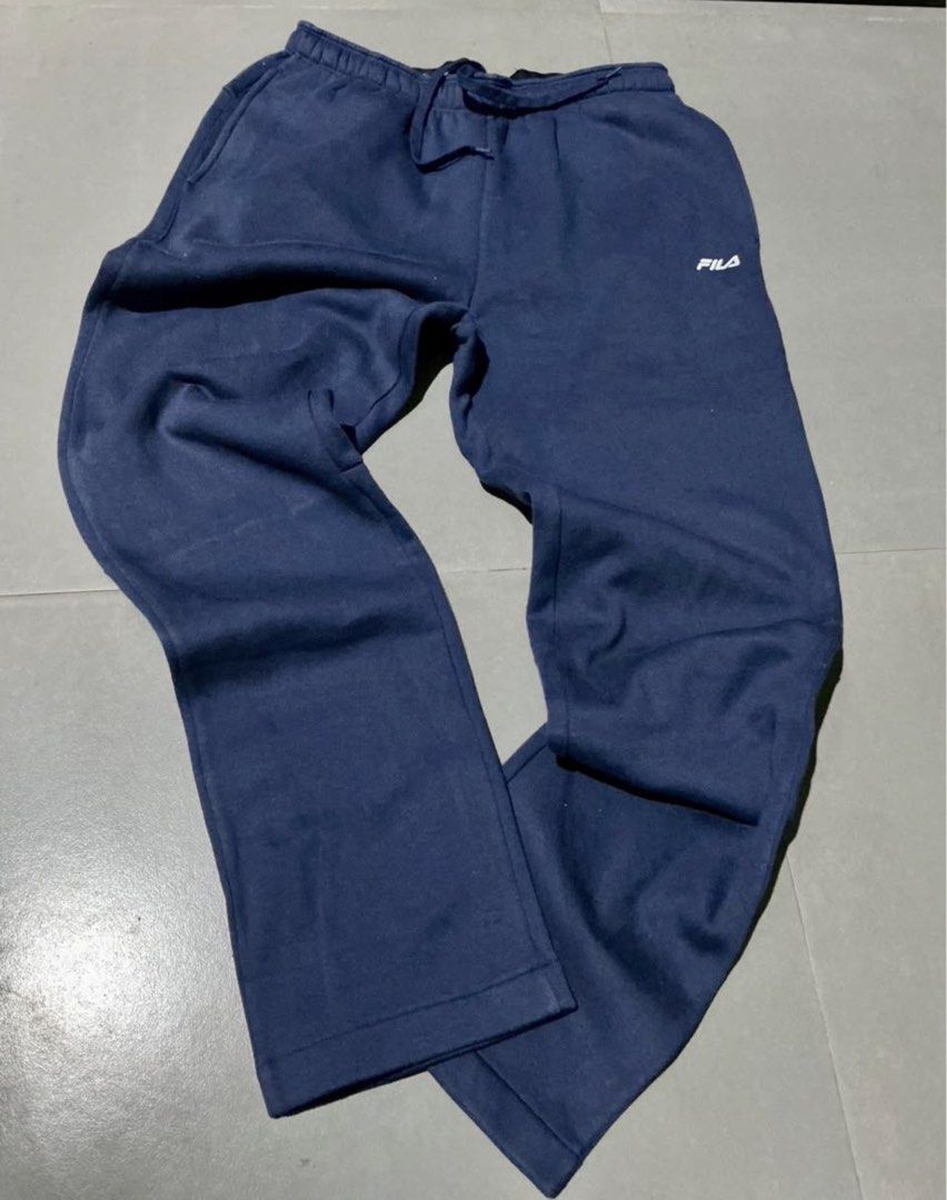 Navy Blue Fila Sweatpants Joggers (Category: Joggers) located in Manila. Submitted by irthrift (Listing ID 1441970855, Image 2). Description: - Navy blue Fila sweatpants - Elastic waistband with drawstring - Fila logo embroidered on the left leg - Comfortable for lounging, workouts, and everyday casual wear.