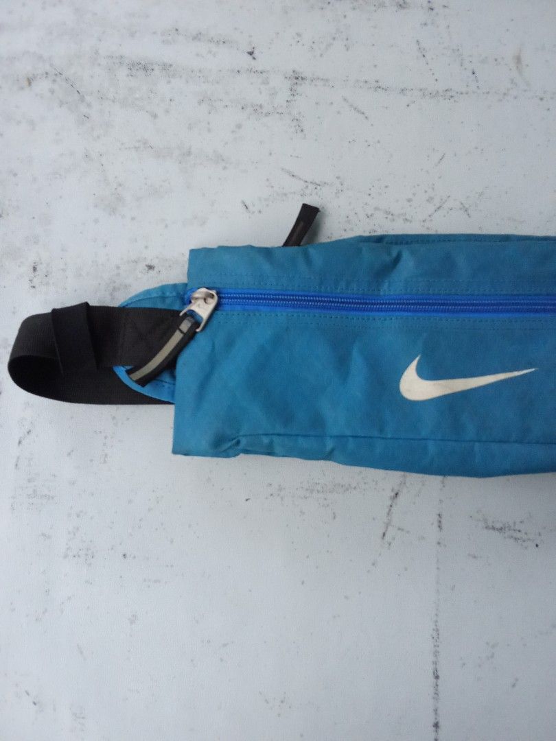 Nike Running Belt Bag Teal Blue (Category: Belt bags, Clutches and Pouches) located in Polomolok. Submitted by timog_high_ice (Listing ID 1442155125, Image 2). Description: - Teal blue Nike running belt bag - Zippered main compartment for secure storage - Adjustable strap with buckle closure for a custom fit - Reflective detail on the zipper pull for visibility - Ideal for carrying essentials during runs and workouts Subrang Pogi nito🫶.