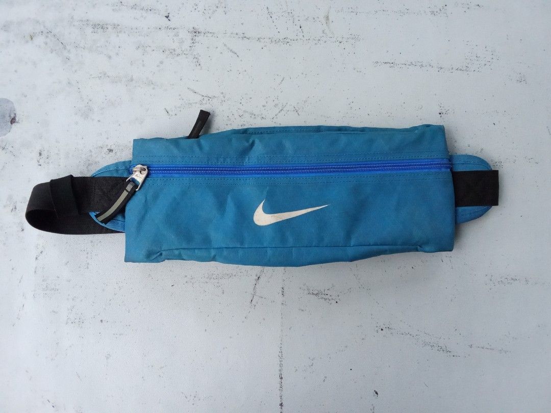 Nike Running Belt Bag Teal Blue (Category: Belt bags, Clutches and Pouches) located in Polomolok. Submitted by timog_high_ice (Listing ID 1442155125, Image 1). Description: - Teal blue Nike running belt bag - Zippered main compartment for secure storage - Adjustable strap with buckle closure for a custom fit - Reflective detail on the zipper pull for visibility - Ideal for carrying essentials during runs and workouts Subrang Pogi nito🫶.