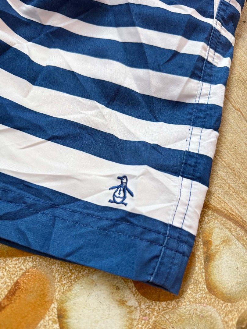 Original Penguin Striped Swim Trunks Blue White (Category: Swim Trunks & Board Shorts) located in Bayambang. Submitted by ace_found_it_06 (Listing ID 1442079463, Image 3). Description: - Original Penguin blue and white striped swim trunks - Features a drawstring waist - Includes back pockets - Iconic Penguin logo on the front - Ideal for beach days or pool lounging DM 📩📩 - Pangasinan Based.