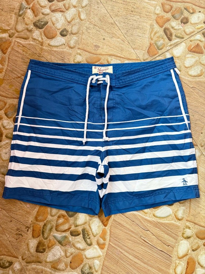 Original Penguin Striped Swim Trunks Blue White (Category: Swim Trunks & Board Shorts) located in Bayambang. Submitted by ace_found_it_06 (Listing ID 1442079463, Image 1). Description: - Original Penguin blue and white striped swim trunks - Features a drawstring waist - Includes back pockets - Iconic Penguin logo on the front - Ideal for beach days or pool lounging DM 📩📩 - Pangasinan Based.
