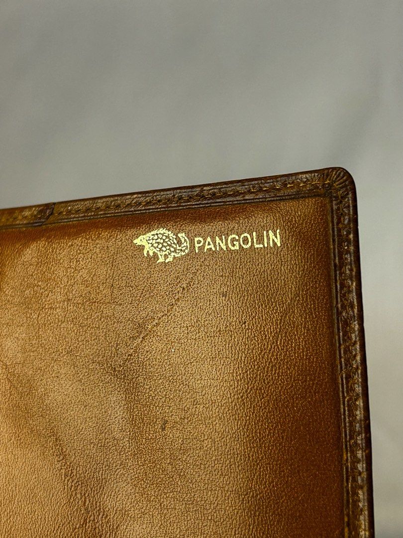 Pangolin Brown Leather Bifold Wallet (Category: Wallets & Card holders) located in Manila. Submitted by originalvintagebagph (Listing ID 1442153764, Image 2). Description: - Genuine brown leather bifold wallet - Unique textured exterior for a stylish look - Pangolin logo embossed inside - Multiple card slots for your essentials - Spacious bill compartment - Classic and durable design, perfect for daily use.
