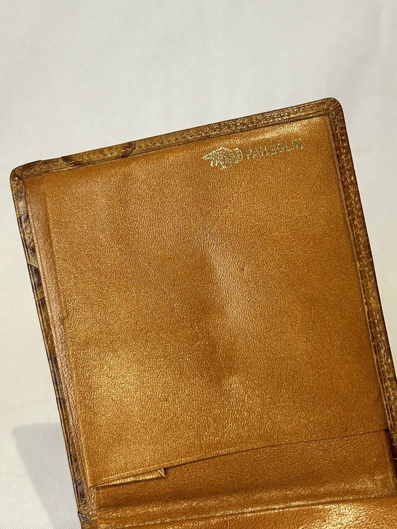 Pangolin Brown Leather Bifold Wallet (Category: Wallets & Card holders) located in Manila. Submitted by originalvintagebagph (Listing ID 1442153764, Image 3). Description: - Genuine brown leather bifold wallet - Unique textured exterior for a stylish look - Pangolin logo embossed inside - Multiple card slots for your essentials - Spacious bill compartment - Classic and durable design, perfect for daily use.