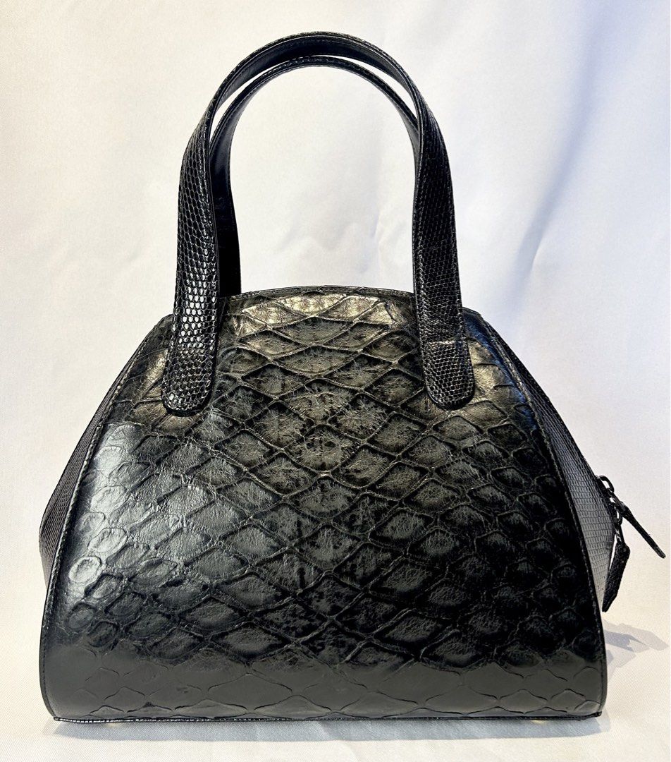 Pangolin X Lizard. Black Handbag with Top Handles (Category: Luxury Bags & Wallets) located in Manila. Submitted by originalvintagebagph (Listing ID 1442153499, Image 2). Description: - Chic black textured handbag - Unique scale-like pattern on front and sides - Two comfortable top handles - Secure zippered closure - Convenient zippered pocket on the back - Durable metal feet on the bottom - Versatile for everyday or special events.
