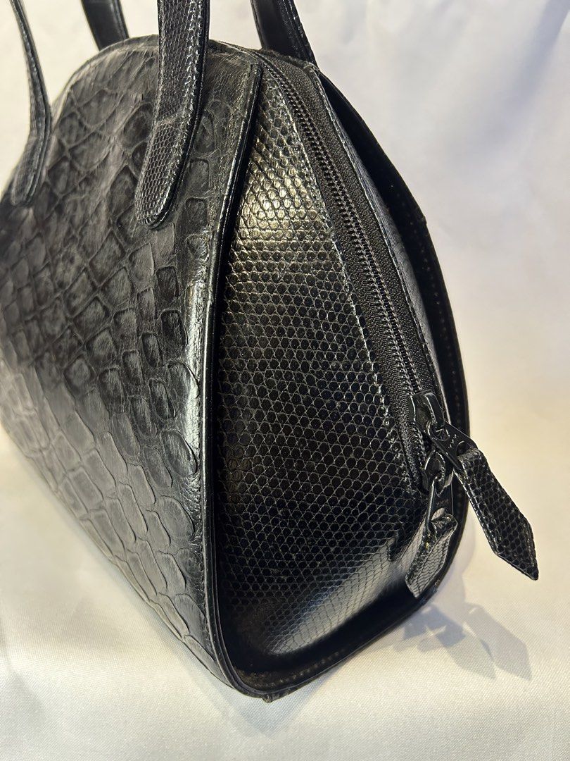 Pangolin X Lizard. Black Handbag with Top Handles (Category: Luxury Bags & Wallets) located in Manila. Submitted by originalvintagebagph (Listing ID 1442153499, Image 3). Description: - Chic black textured handbag - Unique scale-like pattern on front and sides - Two comfortable top handles - Secure zippered closure - Convenient zippered pocket on the back - Durable metal feet on the bottom - Versatile for everyday or special events.