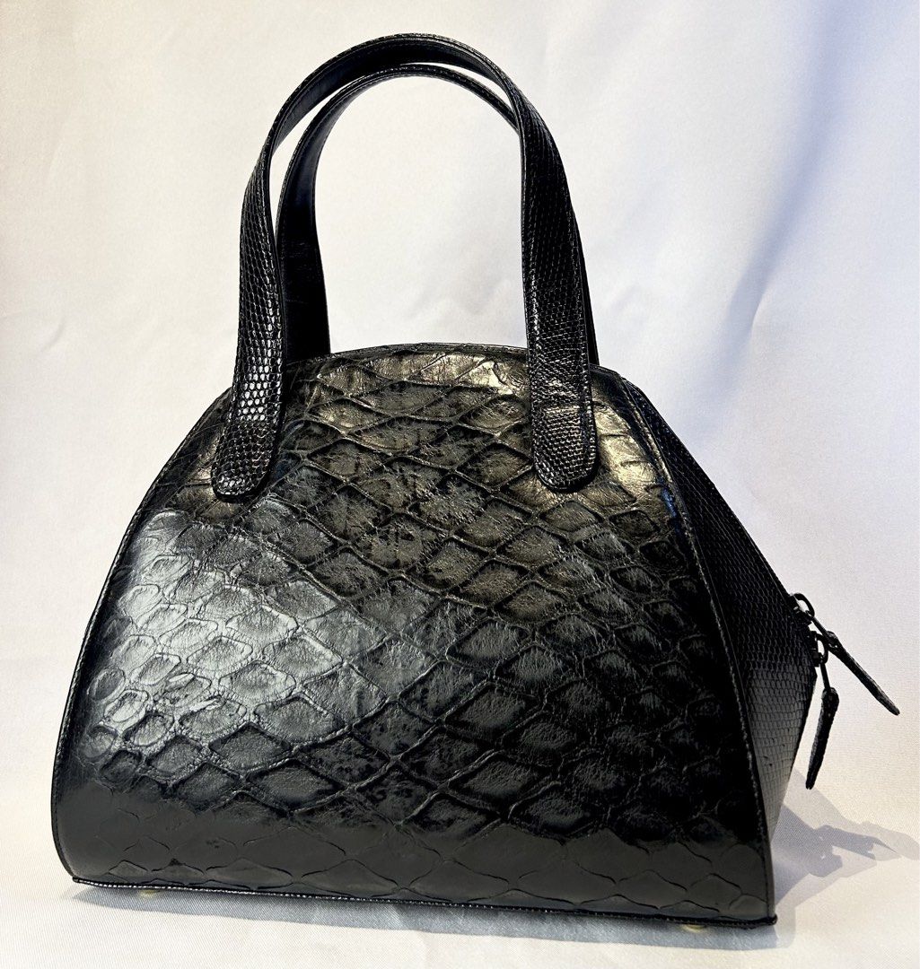 Pangolin X Lizard. Black Handbag with Top Handles (Category: Luxury Bags & Wallets) located in Manila. Submitted by originalvintagebagph (Listing ID 1442153499, Image 1). Description: - Chic black textured handbag - Unique scale-like pattern on front and sides - Two comfortable top handles - Secure zippered closure - Convenient zippered pocket on the back - Durable metal feet on the bottom - Versatile for everyday or special events.