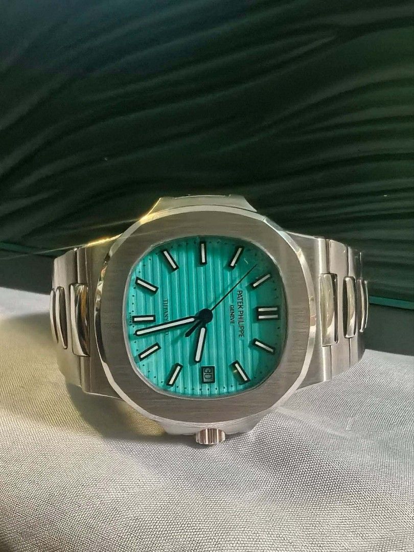 Patek Philippe Nautilus Tiffany Blue Dial Automatic Watch (Category: Luxury Watches) located in Bayugan. Submitted by daniel2019 (Listing ID 1442154121, Image 2). Description: - Patek Philippe Nautilus - Tiffany blue dial with horizontal lines - Date window at 3 o'clock - Stainless steel case and bracelet - Automatic movement (visible case back) - Highly sought-after collector's item.