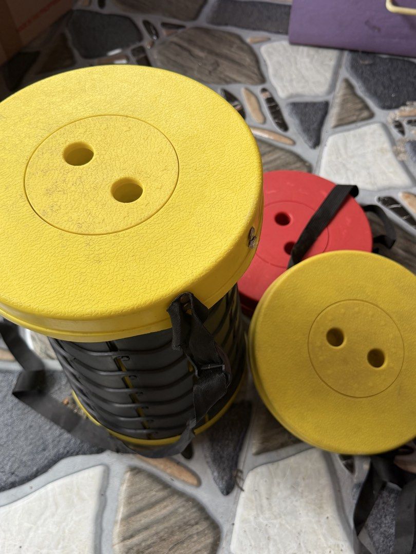 Portable Retractable Stool Yellow and Red (Category: Chairs) located in Del Monte. Submitted by nurse_cheena (Listing ID 1442037026, Image 2). Description: - Set of 2 portable retractable stools (1 yellow, 1 red) - Folds flat for convenient storage and transport - Perfect for camping, outdoor events, or extra home seating - Built-in straps for easy carrying - Minor dust from storage, easily wiped clean.