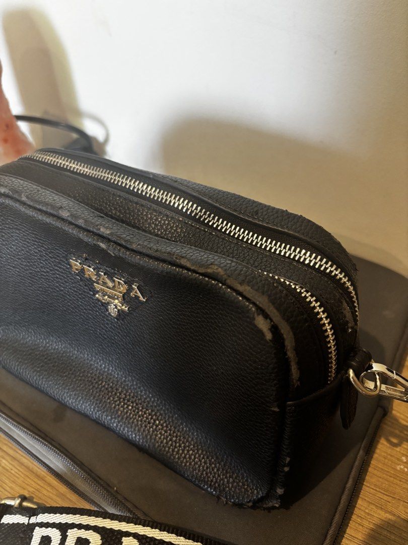 Prada Black Leather Crossbody Bag with White Strap (Category: Luxury Bags & Wallets) located in Bacoor. Submitted by ysadane (Listing ID 1442006951, Image 3). Description: - Silver-tone hardware - Comes with a black and white branded strap - Two working main zippered compartments - Flaws: some leather came off (see photos).