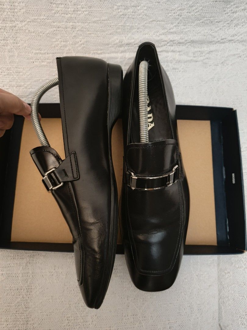 Prada Black Leather Loafers with Silver Buckle (Category: Dress Shoes) located in Makati City. Submitted by emem.pre.owned.ph (Listing ID 1442040636, Image 3). Description: - Classic black leather loafers - Elegant silver buckle detail on the front - Chic square toe design - Perfect for both formal occasions and casual outings.