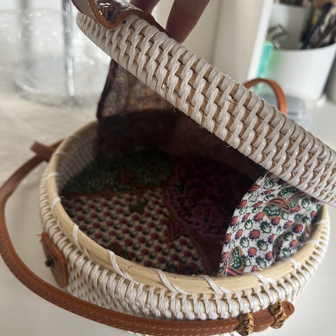 Rattan Round Bag w/ Leather Strap (Category: Cross-body Bags) located in Legazpi City. Submitted by hushedcry (Listing ID 1442028506, Image 2). Description: - White woven exterior - Tan leather strap and details - Colorful patterned fabric lining - Secure snap button closure - for beach days and casual outings - Unique and stylish design - No flaws BNEW rfs: have too many bags :( 💌 mop: gcash / maya accepted 📬 shipping via j&t express (sf c/o b