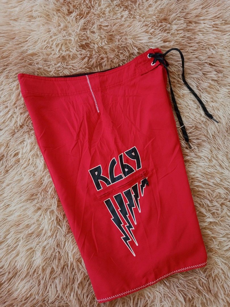 Ripcurl Red Board Shorts with Lightning Bolt Design (Category: Activewear) located in Boston. Submitted by johnpaulvi30029 (Listing ID 1442024620, Image 3). Description: - Red Ripcurl board shorts - Classic Ripcurl logo on the side - Lightning bolt graphic and 'RC69' on front pocket - Zip pocket closure - Drawstring waist - Ideal for beach or pool.