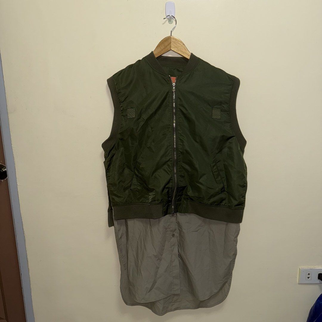 Sacai MA-1 Down Flare Vest (Category: Others Tops) located in Calasiao. Submitted by jafaith_man (Listing ID 1442115818, Image 1). Description: This Sacai MA-1 down flare vest features a distinctive hybrid design combining a technical nylon bomber upper with a draped, handkerchief hem. Size 1 Small frame Length 35 in. Width 21 in. .