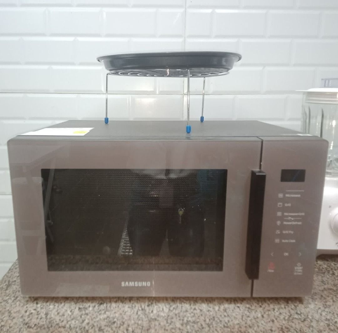 Samsung Microwave Oven with Steamer Rack (Category: Ovens & Toasters) located in Caloocan City. Submitted by moreventures_1024 (Listing ID 1442054598, Image 1). Description: - Grey Samsung Microwave Oven - Works well, reliable performance - Comes with a steamer rack for versatile cooking - Ideal for reheating food and preparing small meals - User-friendly controls located on the side - A great addition to any kitchen.