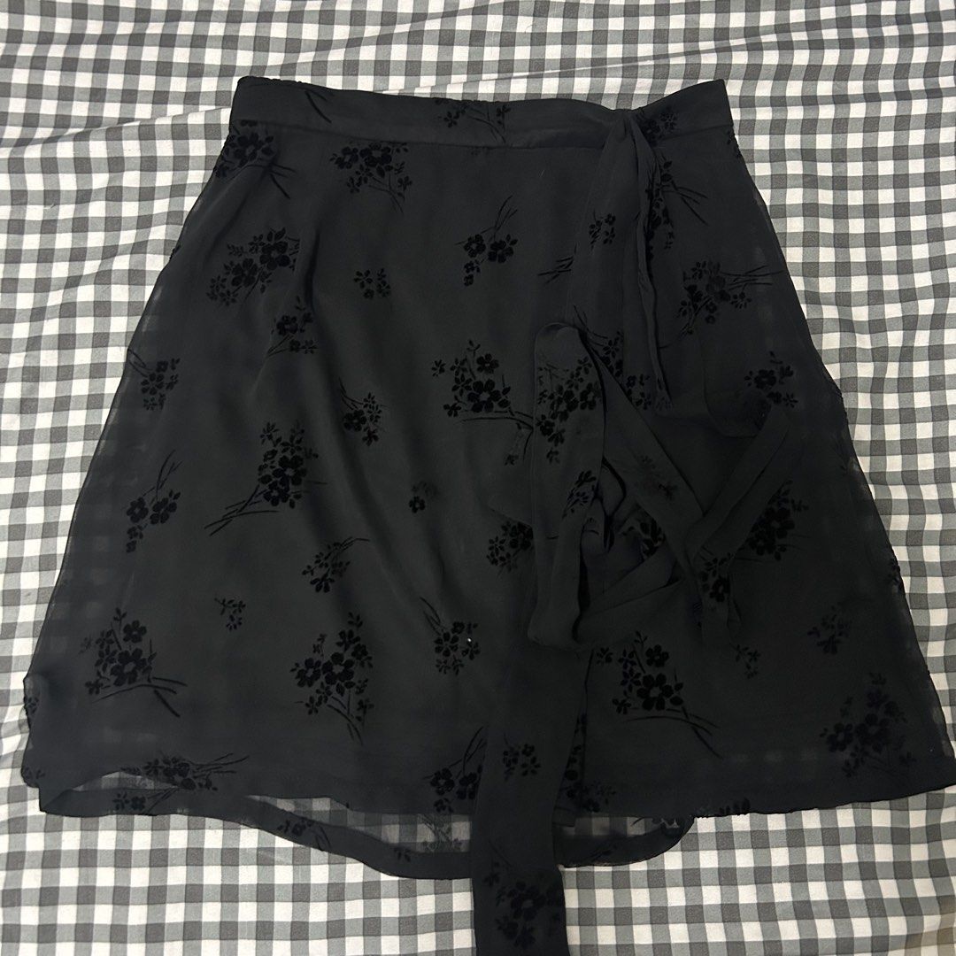 Snidel Black Floral Wrap Skirt (Category: Skirts) located in Manila. Submitted by worstdumpling (Listing ID 1442085990, Image 1). Description: - Brand: Snidel - Type: Black wrap skirt - Design: Delicate floral burnout pattern - Material: Sheer overlay with satin lining - Closure: Tie waist - Style: Super cute, versatile for dressing up or down.