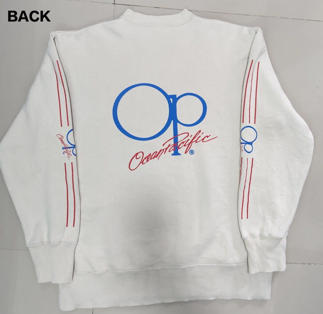 VTG Ocean Pacific OP White Sweatshirt (Category: Coats, Jackets and Outerwear) located in Cavite. Submitted by whew12 (Listing ID 1442009724, Image 2). Description: This item is a vintage Ocean Pacific (OP) crewneck sweatshirt featuring a clean off-white body with contrasting red and blue racing stripes running down the length of both sleeves. - White Ocean Pacific sweatshirt - Features OP logo on back and sleeve - Red and blue stripe details on 