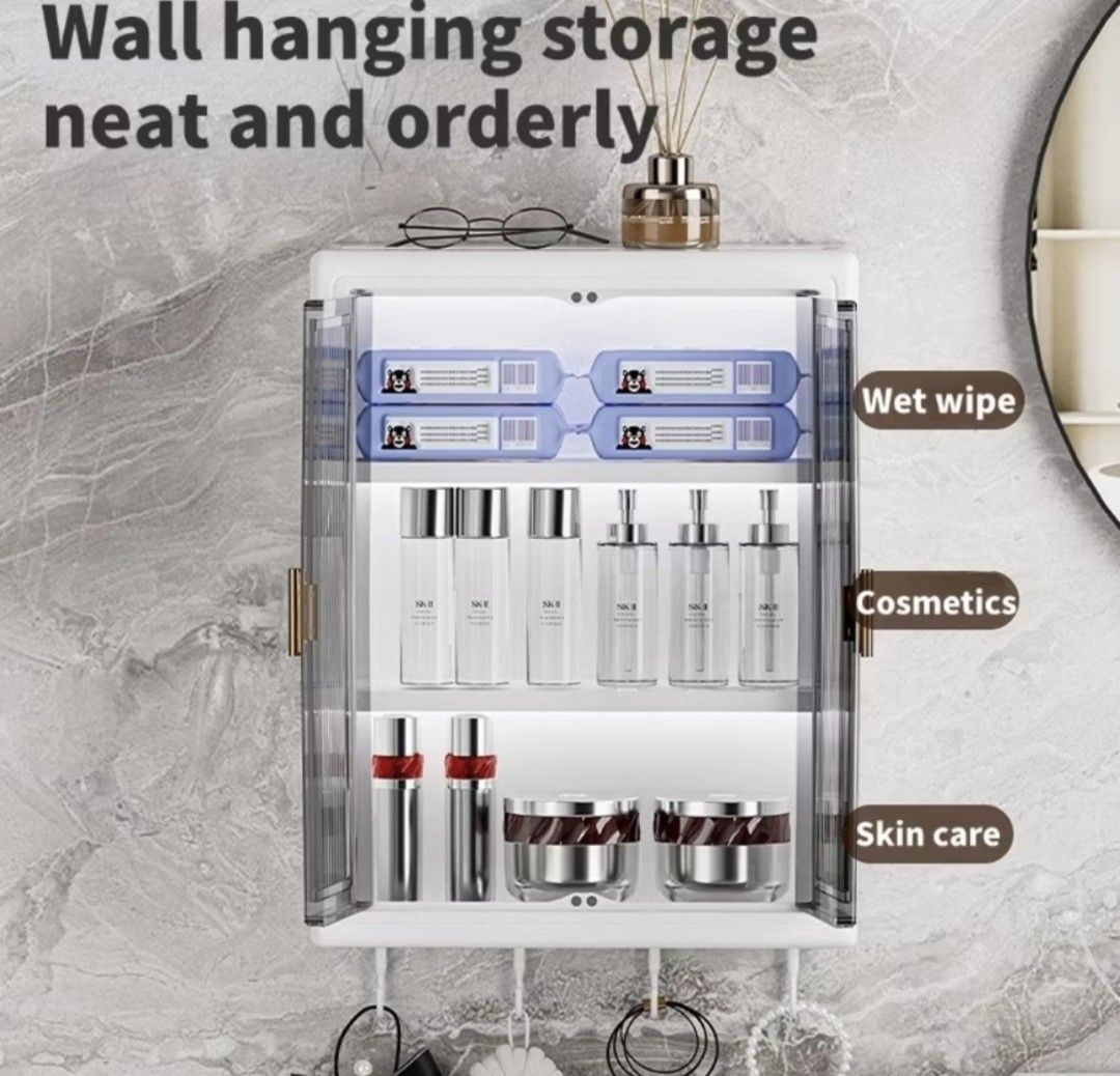Wall Mounted Storage Cabinet with Hooks (Category: Shelves, Cabinets & Racks) located in Manila. Submitted by weyt_k (Listing ID 1442079488, Image 3). Description: - White wall hanging storage cabinet - Features two clear doors with ribbed texture - Includes 4 hooks at the bottom for hanging - Ideal for organizing cosmetics, skincare, and small items - Dimensions: 31cm (W) x 40cm (H) x 12cm (D) - Keeps your space neat and tidy.