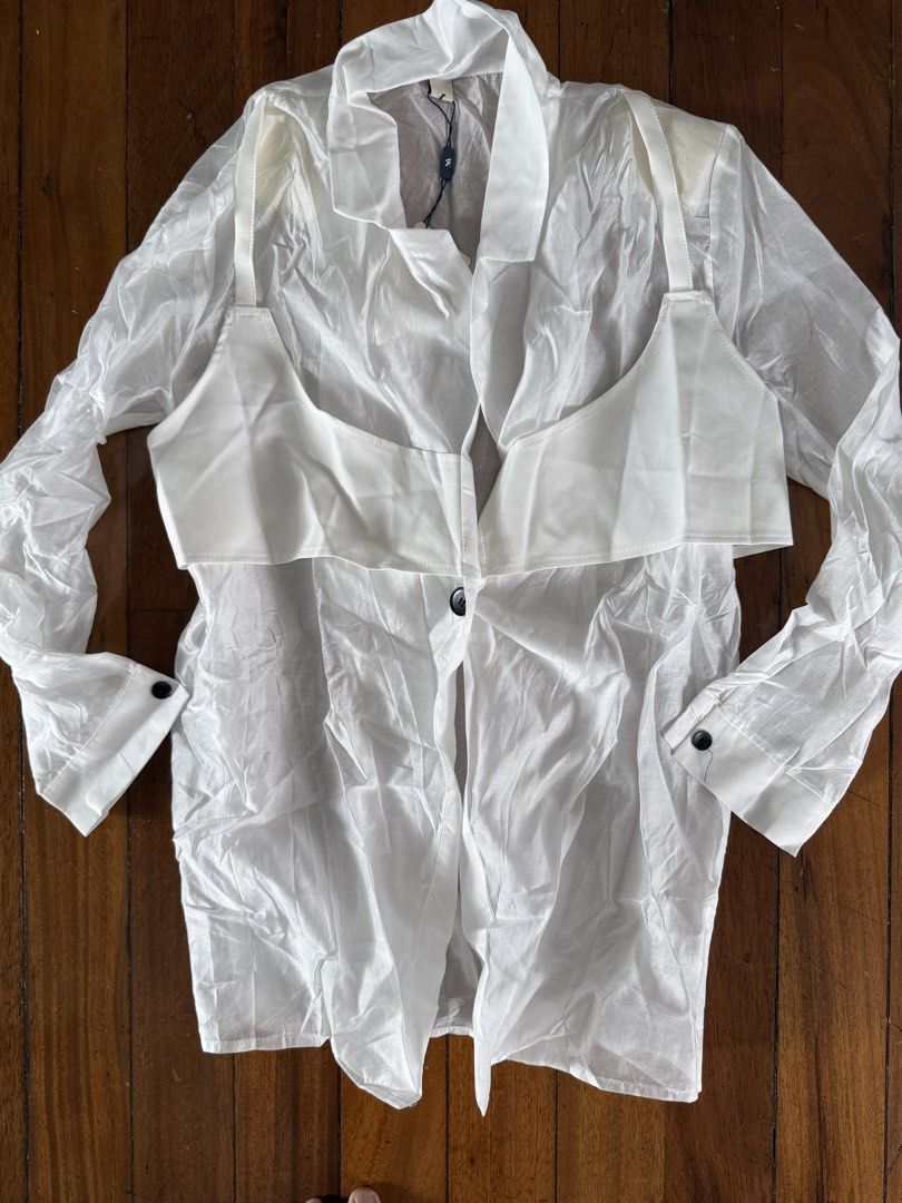 White Sheer Oversized Blazer with Detachable Bralette (Category: Coats, Jackets and Outerwear) located in Pasig City. Submitted by atbp__ (Listing ID 1441993937, Image 3). Description: - White sheer oversized blazer - Includes detachable bralette - Front button closure - Adjustable ties at the back - Long sleeves with button cuffs - Versatile for layering over dresses or tops - Unique and stylish design.