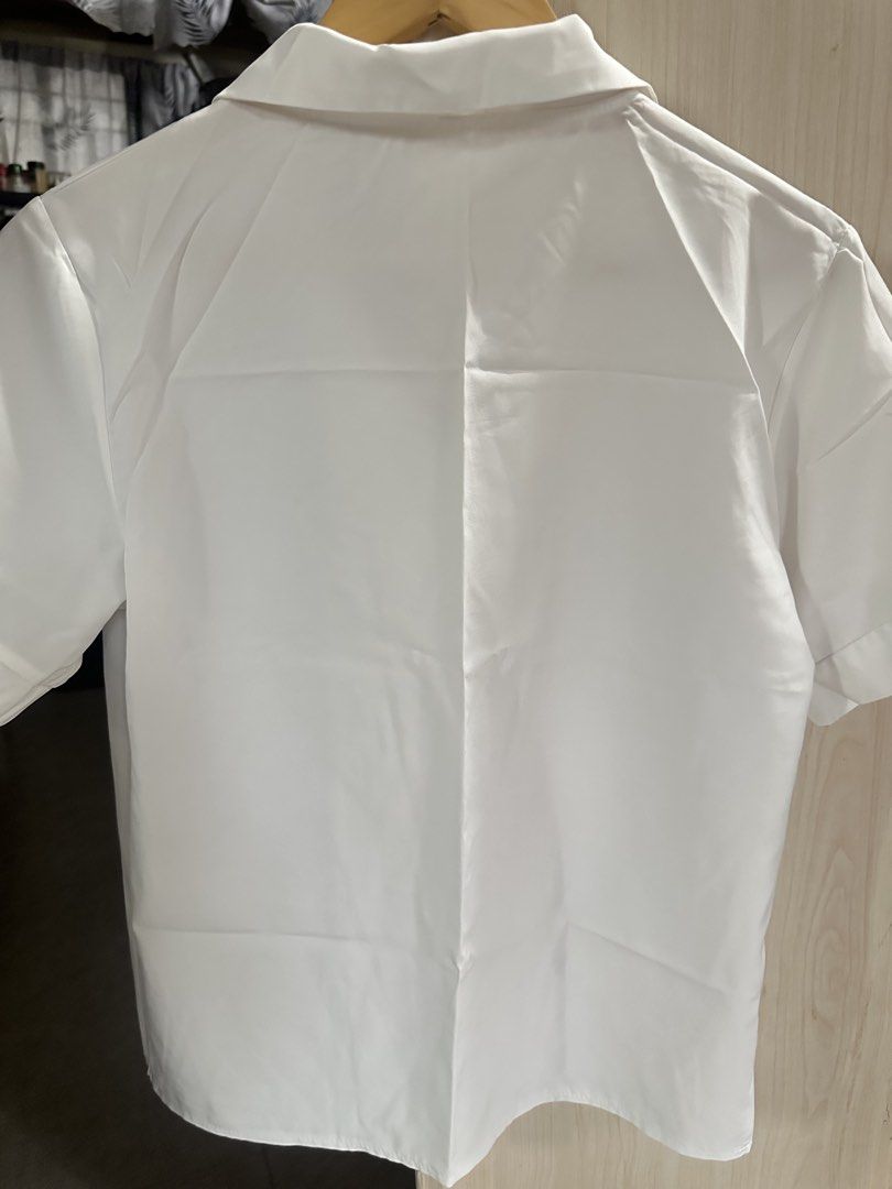 White Short Sleeve Button Up Shirt (Category: Shirts) located in Valenzuela. Submitted by _minchin (Listing ID 1442109391, Image 2). Description: - Classic white short sleeve shirt - Button-up front with a collar - Simple and clean design - Versatile for uniforms or casual wear - Effortless to pair with any outfit - Offers a crisp and neat appearance - manipis.