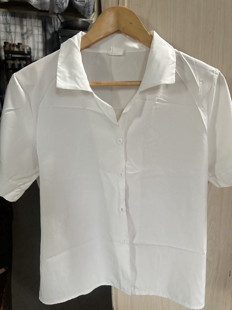 White Short Sleeve Button Up Shirt (Category: Shirts) located in Valenzuela. Submitted by _minchin (Listing ID 1442109391, Image 1). Description: - Classic white short sleeve shirt - Button-up front with a collar - Simple and clean design - Versatile for uniforms or casual wear - Effortless to pair with any outfit - Offers a crisp and neat appearance - manipis.